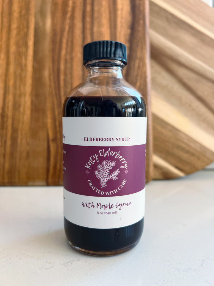 8 oz bottle of Katy Elderberry organic elderberry syrup with maple, a small-batch immune support supplement.