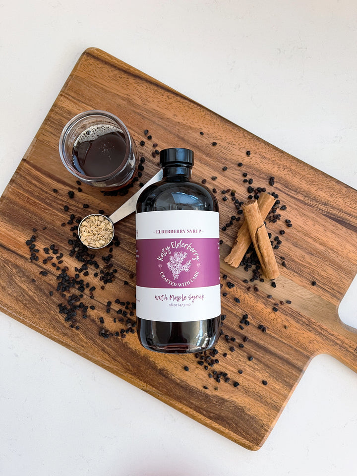 16 oz bottle of Katy Elderberry organic elderberry syrup with maple, a small-batch immune support supplement."